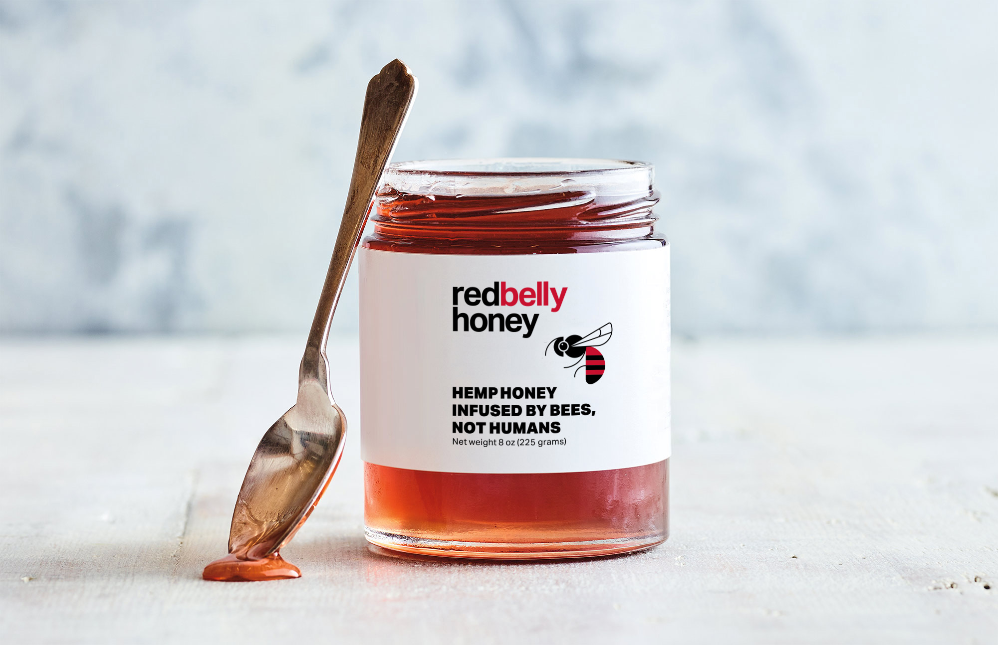 Open honey jar with spoon